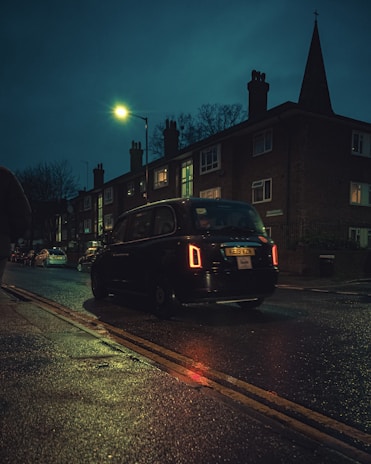 black car on road during night time