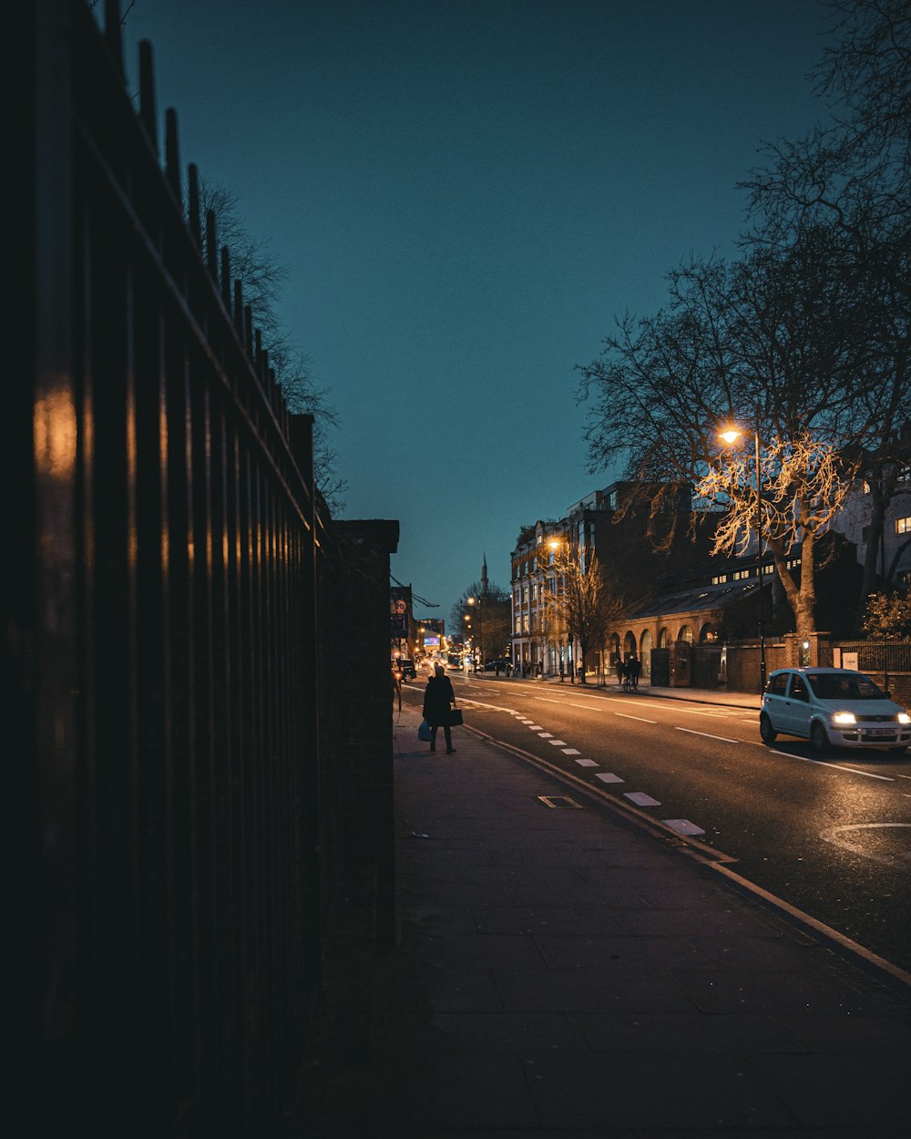 cars parked on side of the road during night time