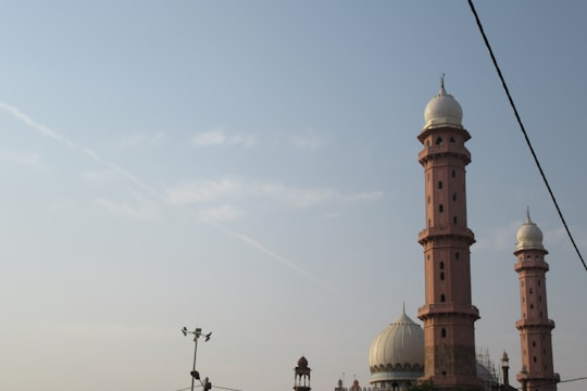 white and gold dome building under blue sky during daytime in Taj Ul Masajid BHOPAL India