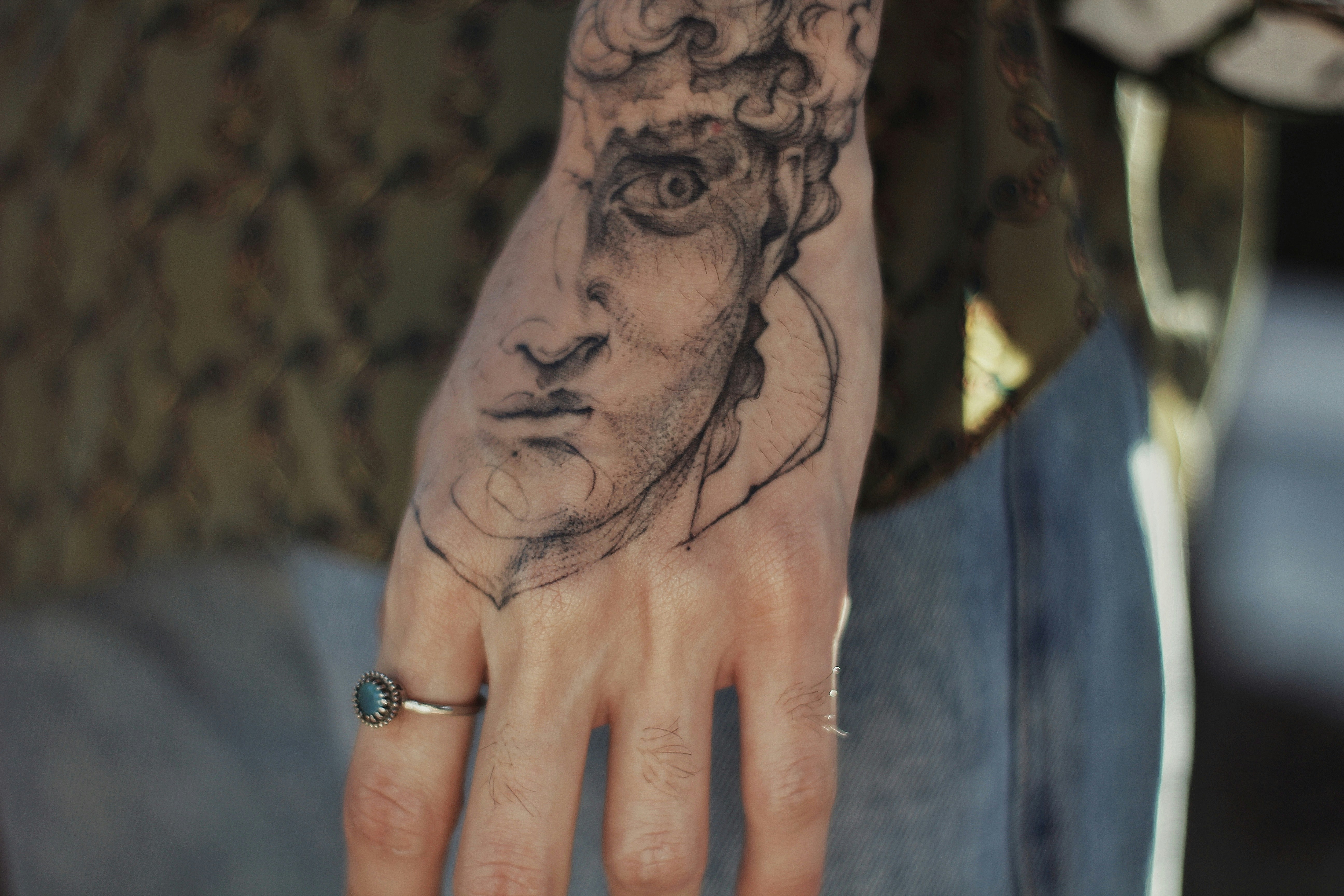 Tattoo artist with black rose tattoo