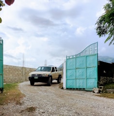 A large truck smoothly entering the parking area through a wide gate