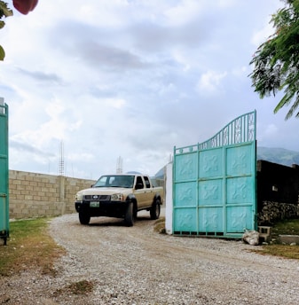 A large truck smoothly entering the parking area through a wide gate