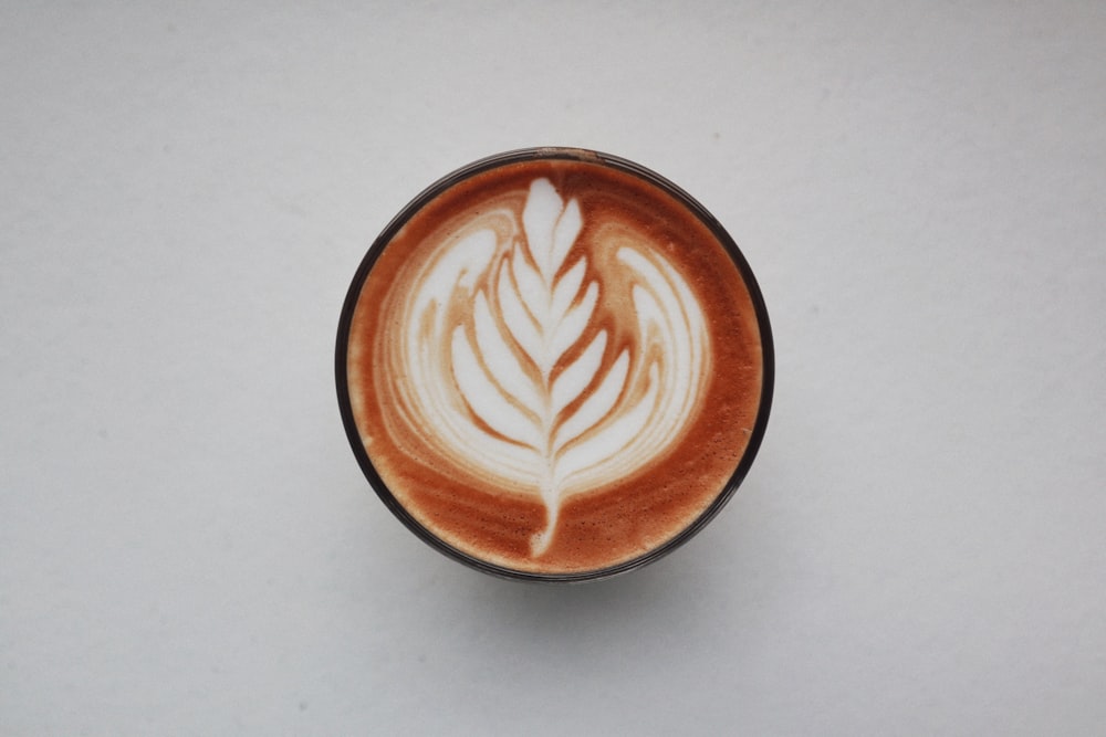 brown and white heart shaped cappuccino