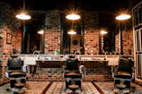 black leather barber chair near brown brick wall