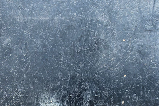 Close-up of the texture and scratch-resistant surface of a premium aluminium metal poster with a gloss finish.
