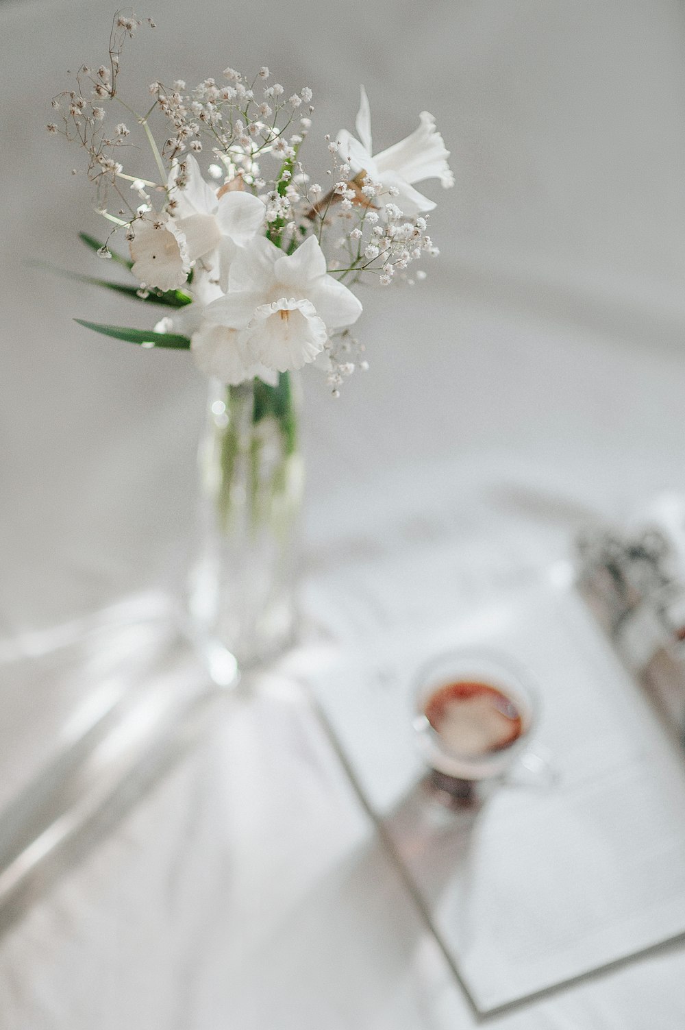 white flowers in clear glass vase