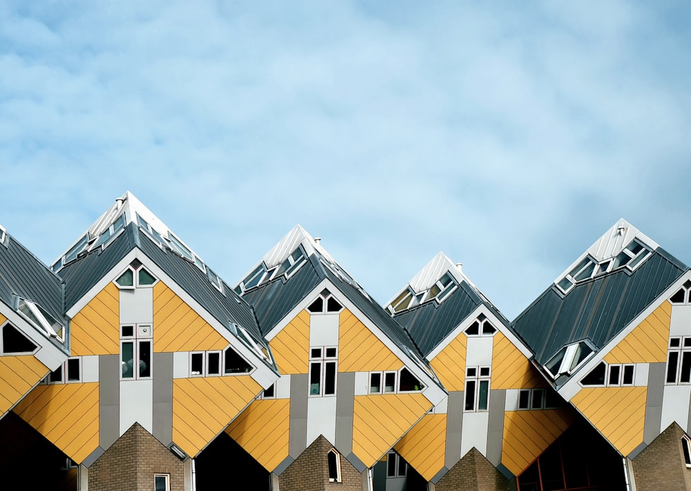 brown and gray wooden houses under white clouds and blue sky during daytime