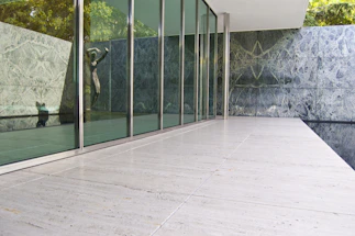 A sleek granite quarry office with golden accents and a traditional temple pattern backdrop