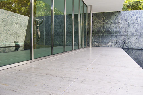 A sleek granite quarry office with golden accents and a traditional temple pattern backdrop