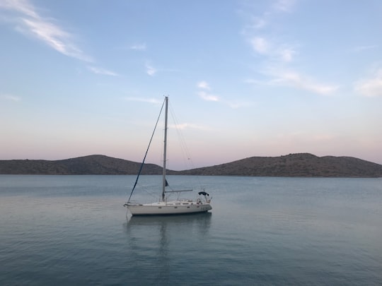 white sail boat on sea during daytime in Crete Greece