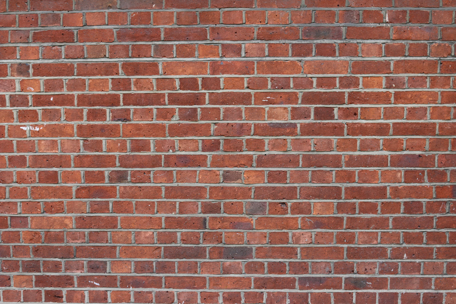Clean red brick wall laid in running bond pattern