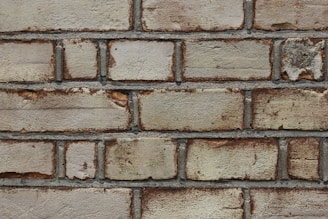Side view of a brick wall treated with a weather-resistant coating, resisting rain and wear.