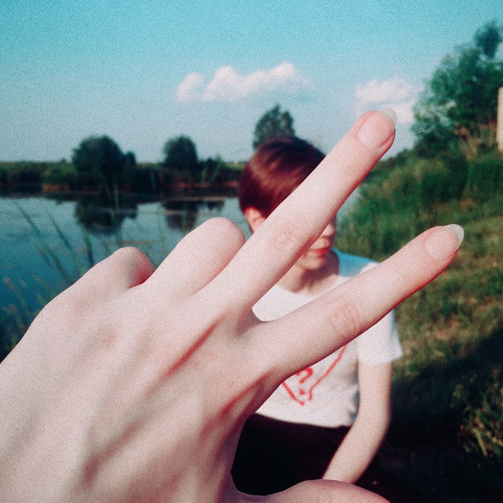 woman in black shirt doing peace sign