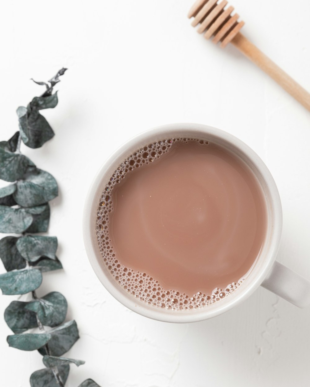 white ceramic mug with brown liquid