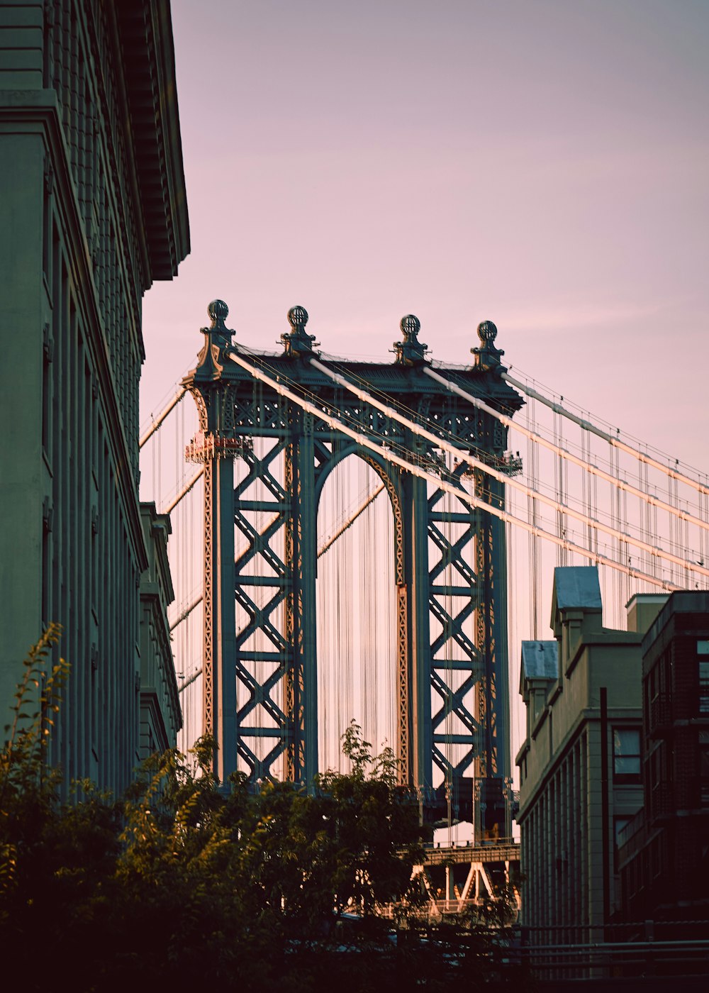 man in black jacket standing on bridge during daytime