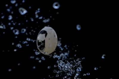 A slow-motion shot of slime bubbles popping with a shiny, iridescent surface.
