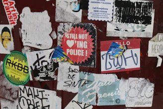 Collection of vibrant punk-style stickers scattered on a black surface.