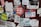 A collection of peeling and overlapping stickers on a surface, featuring a variety of designs and texts. Some stickers are worn out, and the phrases include humorous or rebellious messages. The surface appears weathered and adds to the chaotic arrangement.