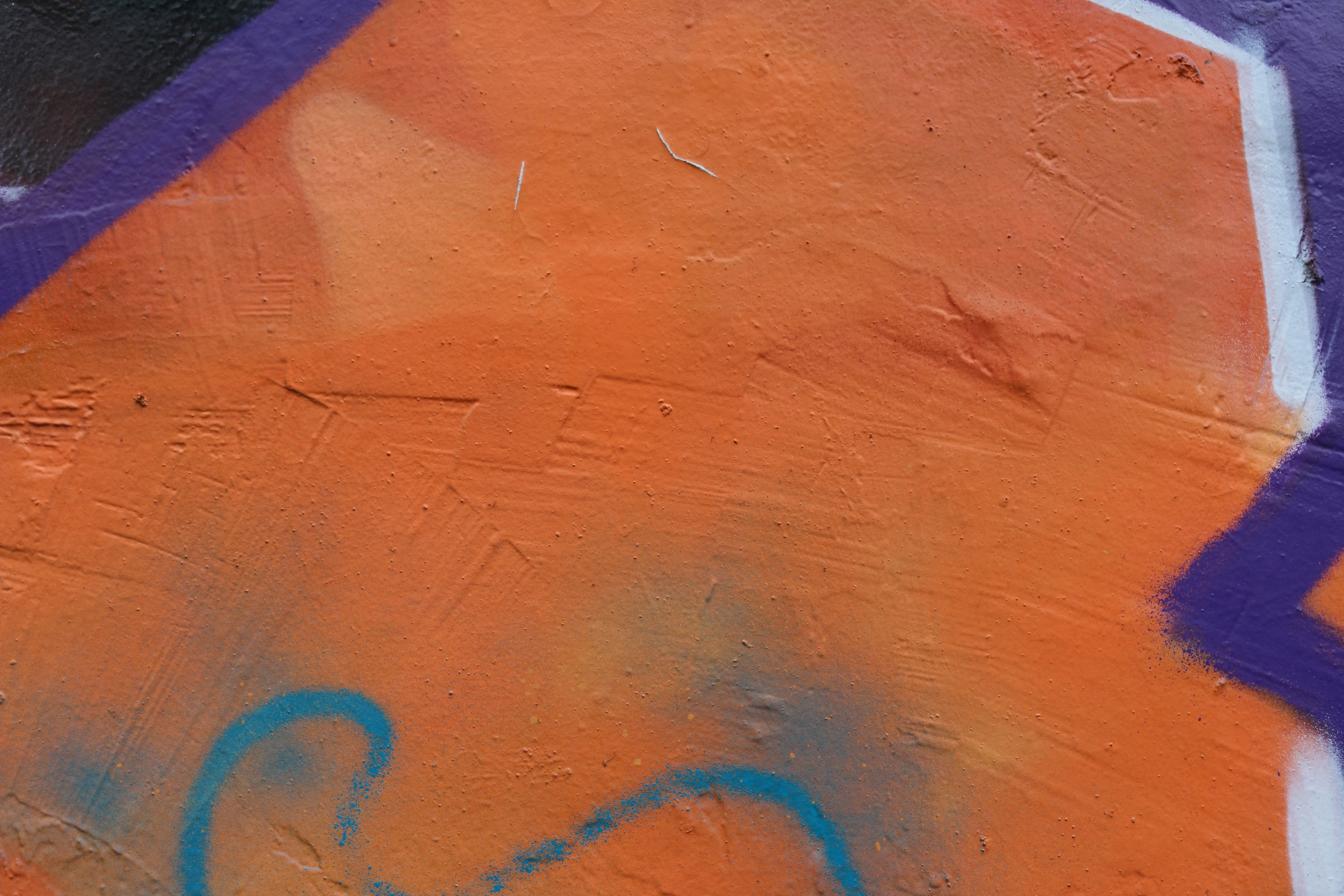Paint-splattered creative studio wall with bright orange and blue color swatches