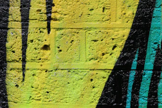 Close-up of vibrant UV printed mural on textured brick wall.