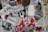 A vibrant collage of various stickers and posters layered on a surface, featuring diverse typography, logos, graphic illustrations, and cartoon characters. Some prominent logos include 'Slow Jams,' 'Timber Boards,' and 'Twizted Movements.' There are illustrations of a sinister cartoon figure and other abstract designs.