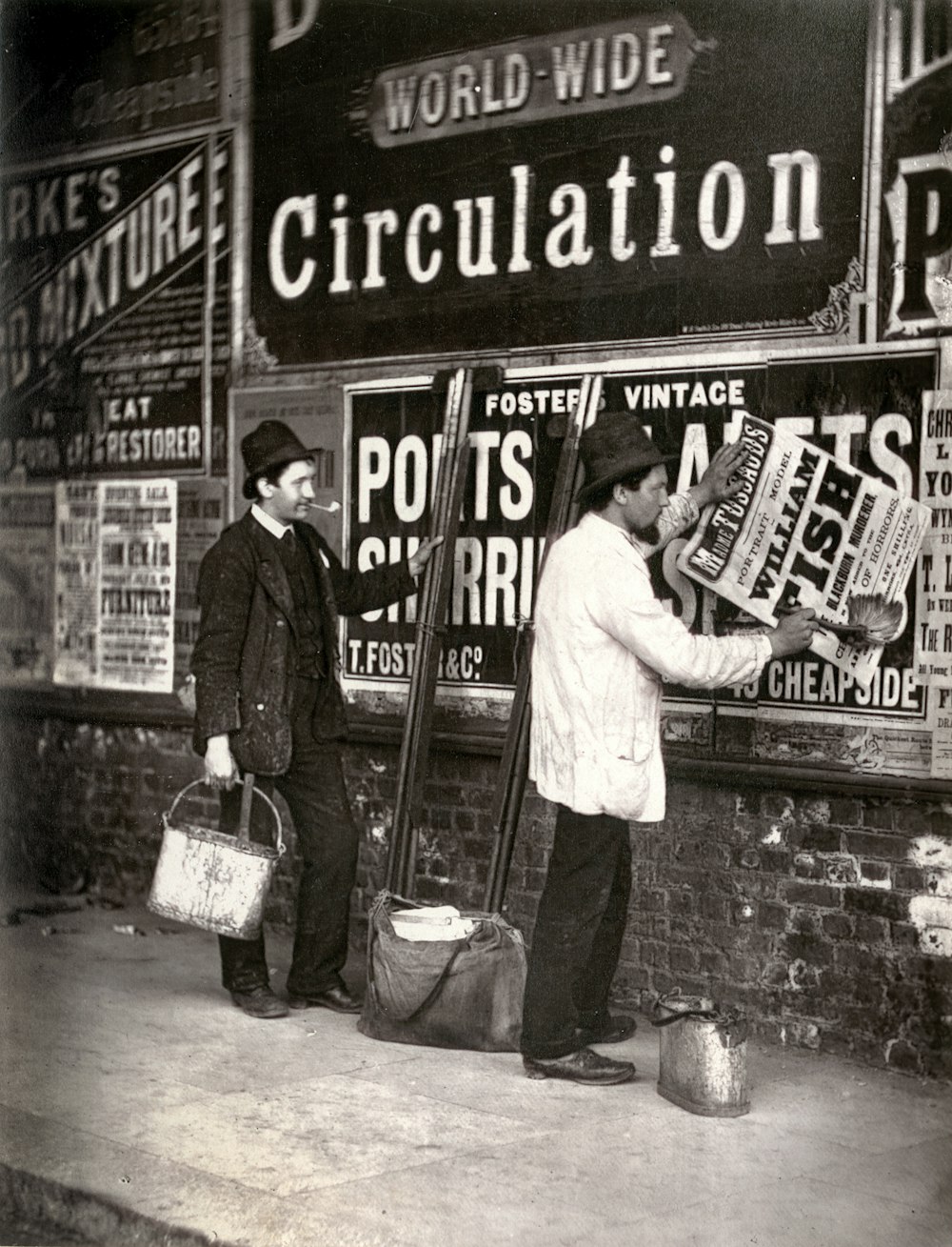 grayscale photo of man and woman standing in front of the UNKs kitchen