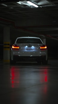white car on road during night time