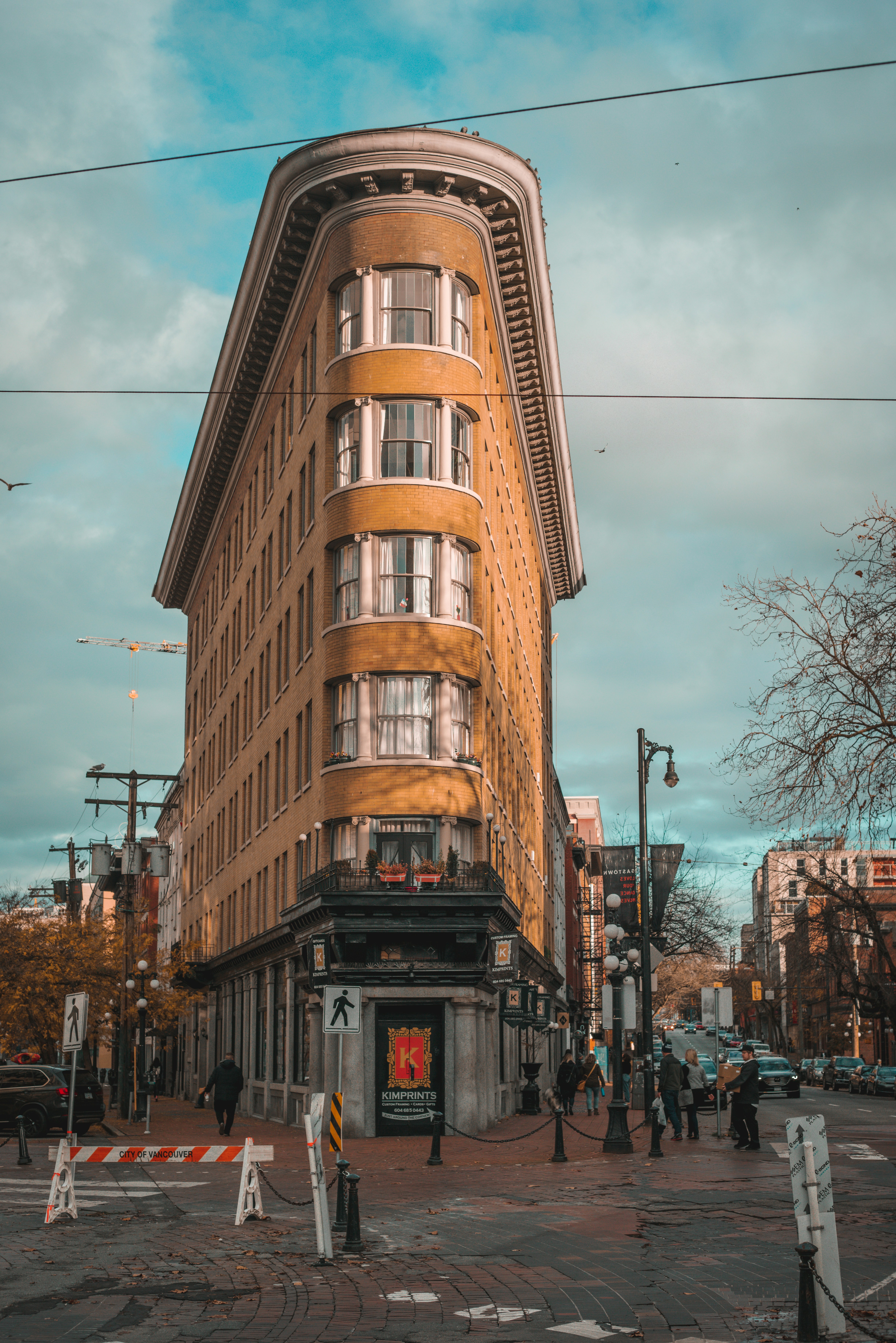 Brown concrete building near brown bare trees during daytime photo ...