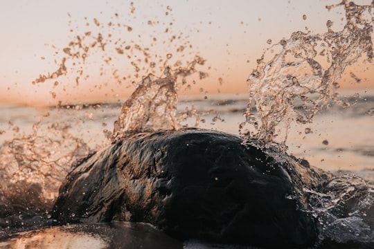 water splash on brown rock in Jūrmala Latvia