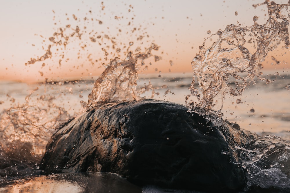 water splash on brown rock