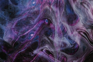 Swirling patterns of dark purple, black, and blue create a cosmic and abstract visual. Wisps of light and shadow weave together, evoking a sense of depth and mystery.