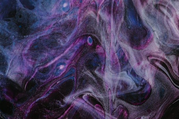 Abstract violet and burgundy light patterns blending into deep black.