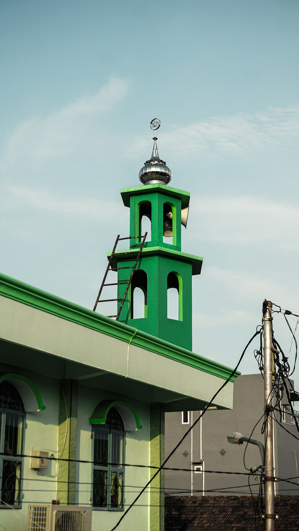 green and white concrete building under white clouds during daytime