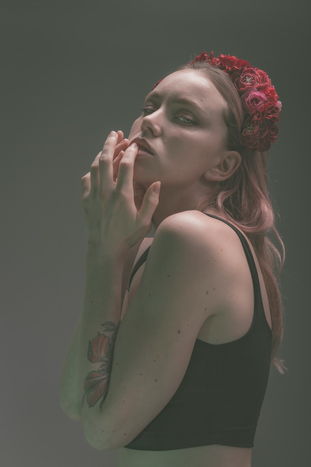 woman in black tank top with red floral head band