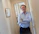 A happy middle-aged man standing proudly next to a modern Garofoli door in a bright living room.