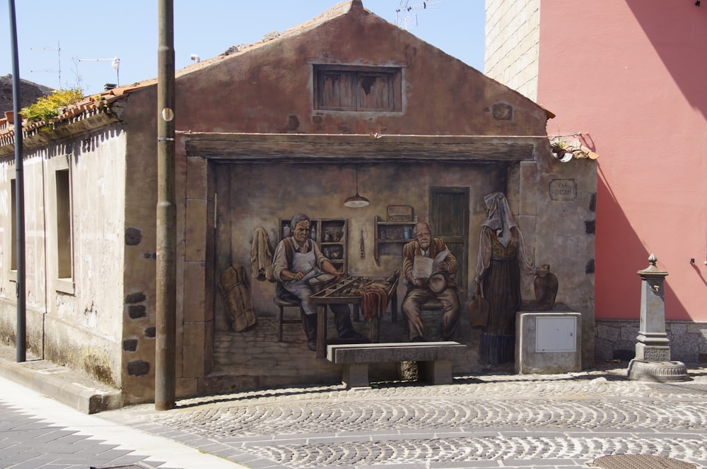 brown concrete building with people and horses statues