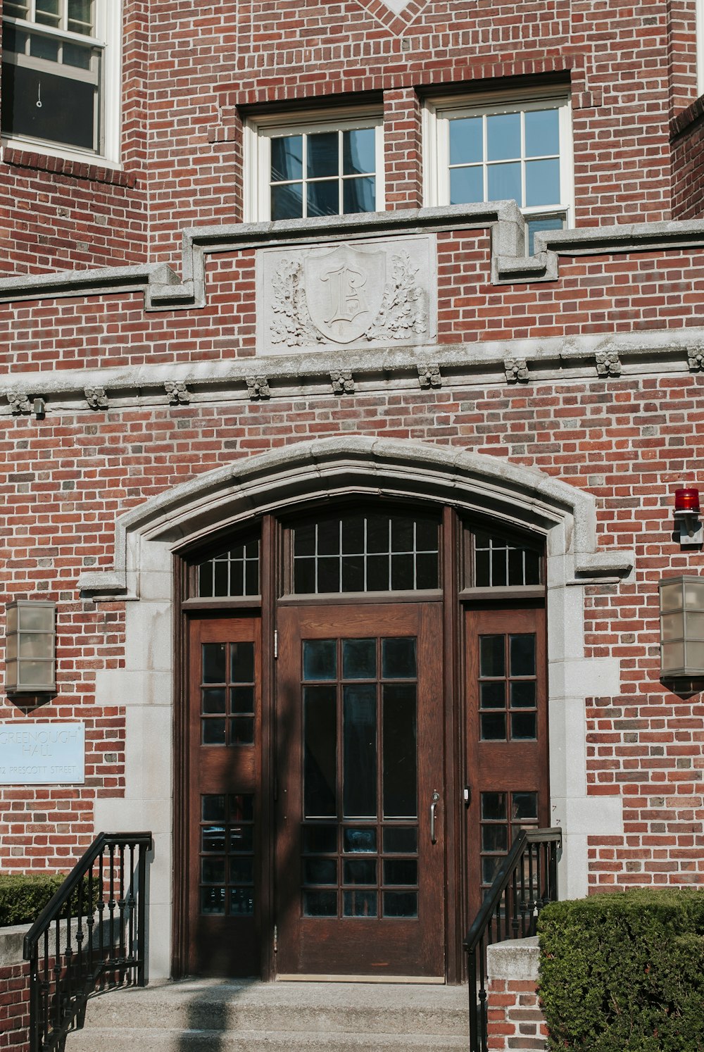 brown wooden door on brown brick building