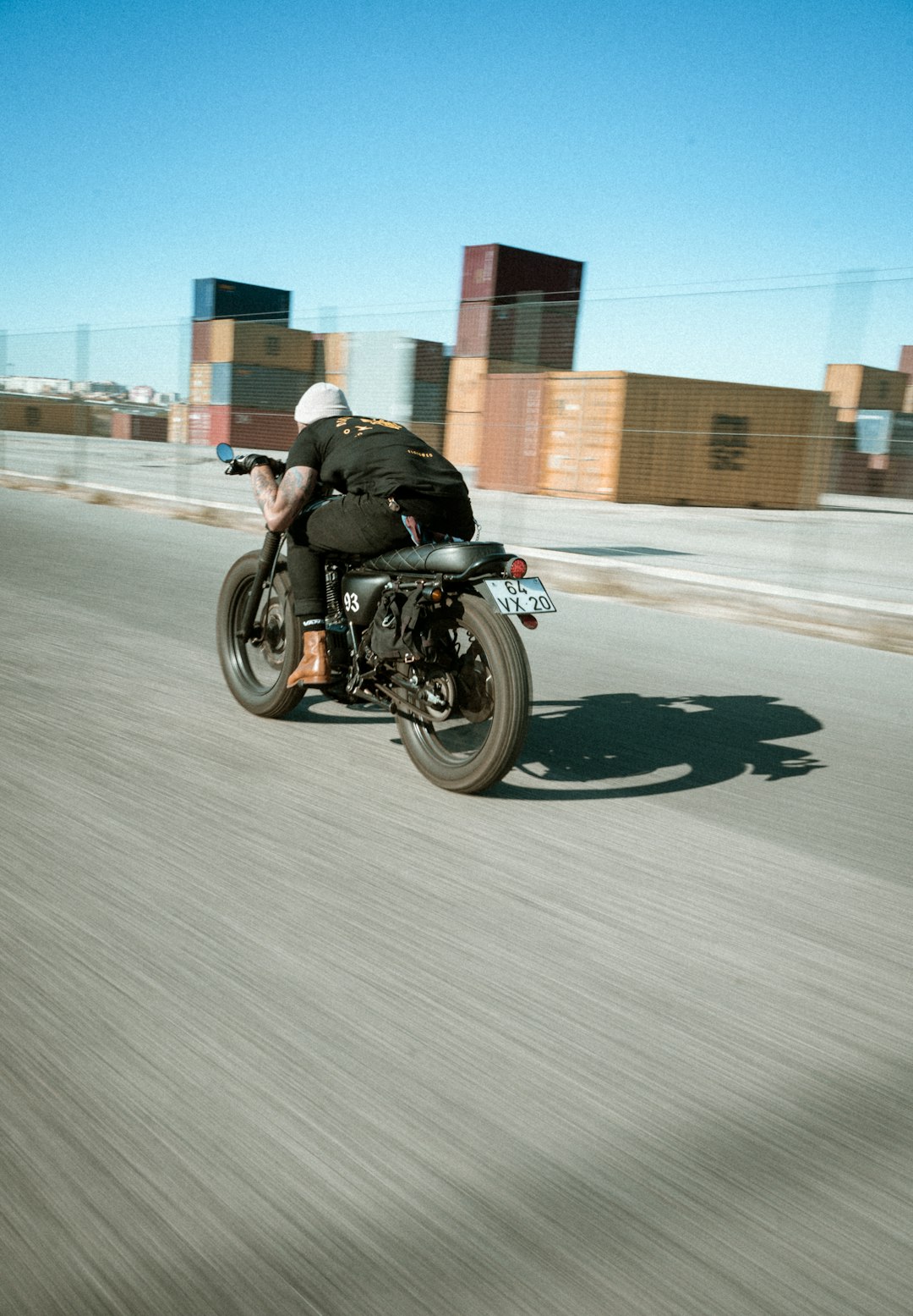 man in black jacket riding motorcycle on road during daytime