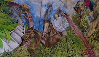 A detailed mural depicts a man wearing traditional clothing riding a horse. The background features large musical instruments, vibrant green plants, a modern building, and rural scenes with a farmhouse and people engaged in daily activities.