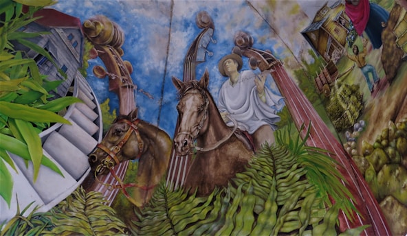 A detailed mural depicts a man wearing traditional clothing riding a horse. The background features large musical instruments, vibrant green plants, a modern building, and rural scenes with a farmhouse and people engaged in daily activities.