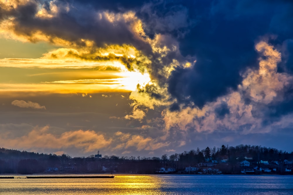 body of water under cloudy sky during daytime