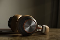 white and black headphones on brown wooden table