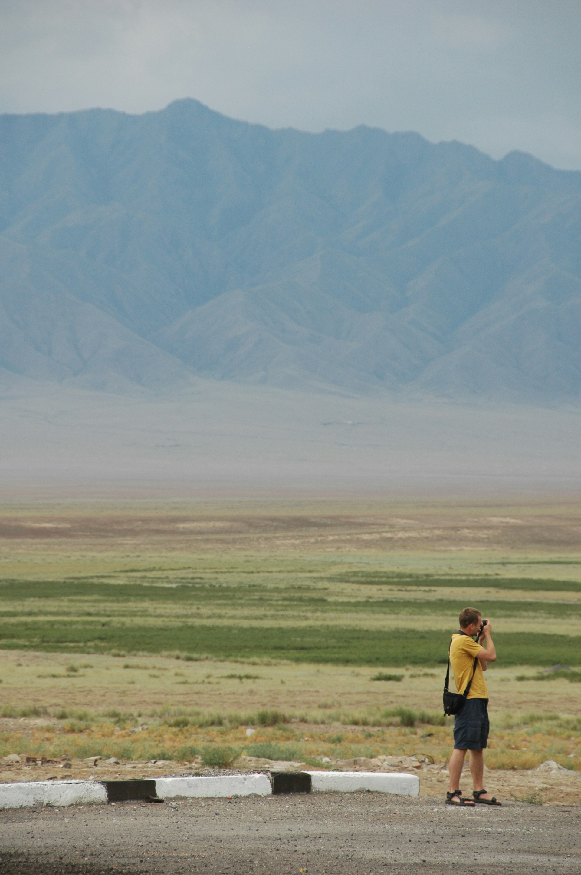 woman wearing yellow long-sleeved dress under white clouds and blue sky during daytime