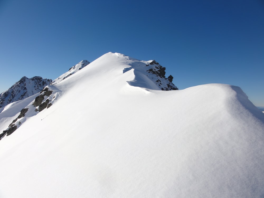 snow covered mountain under blue sky during daytime