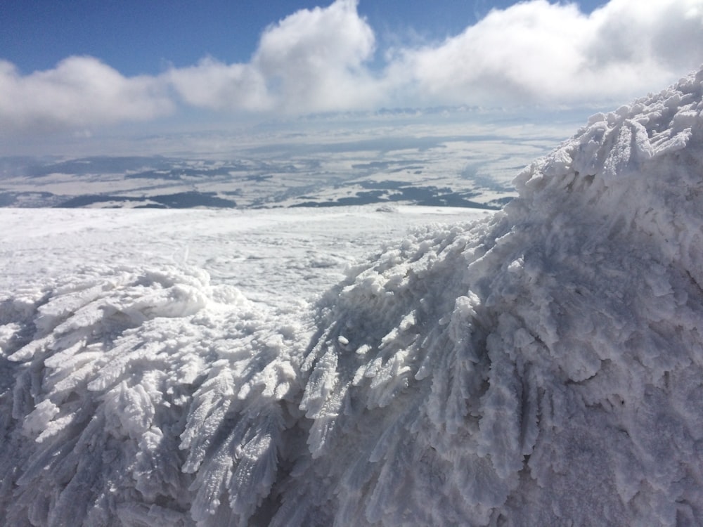 white clouds over snow covered mountain