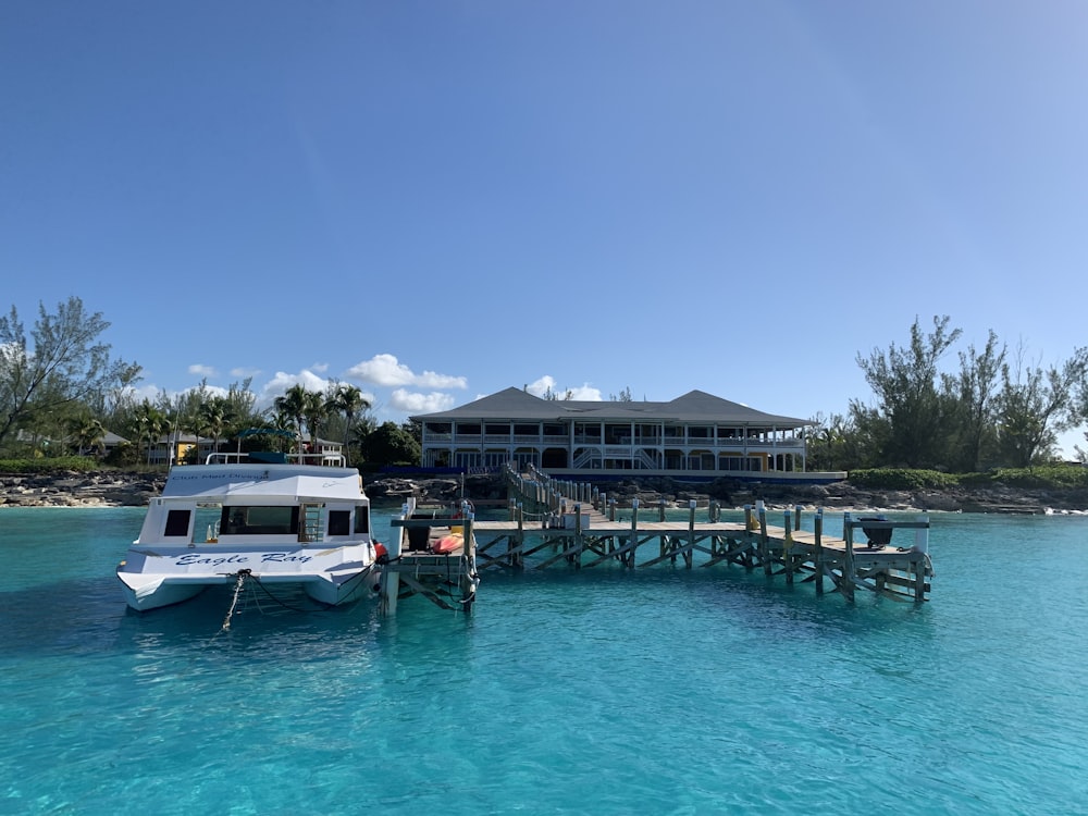 white and blue boat on blue body of water during daytime