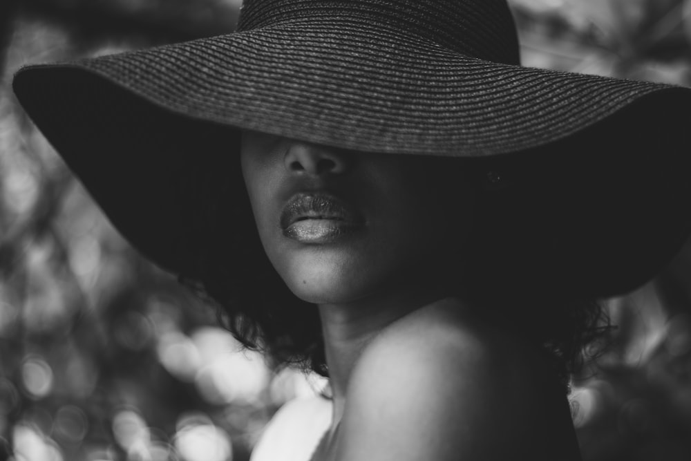 grayscale photo of woman wearing sun hat