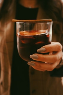 person holding clear drinking glass