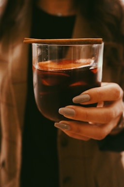 person holding clear drinking glass