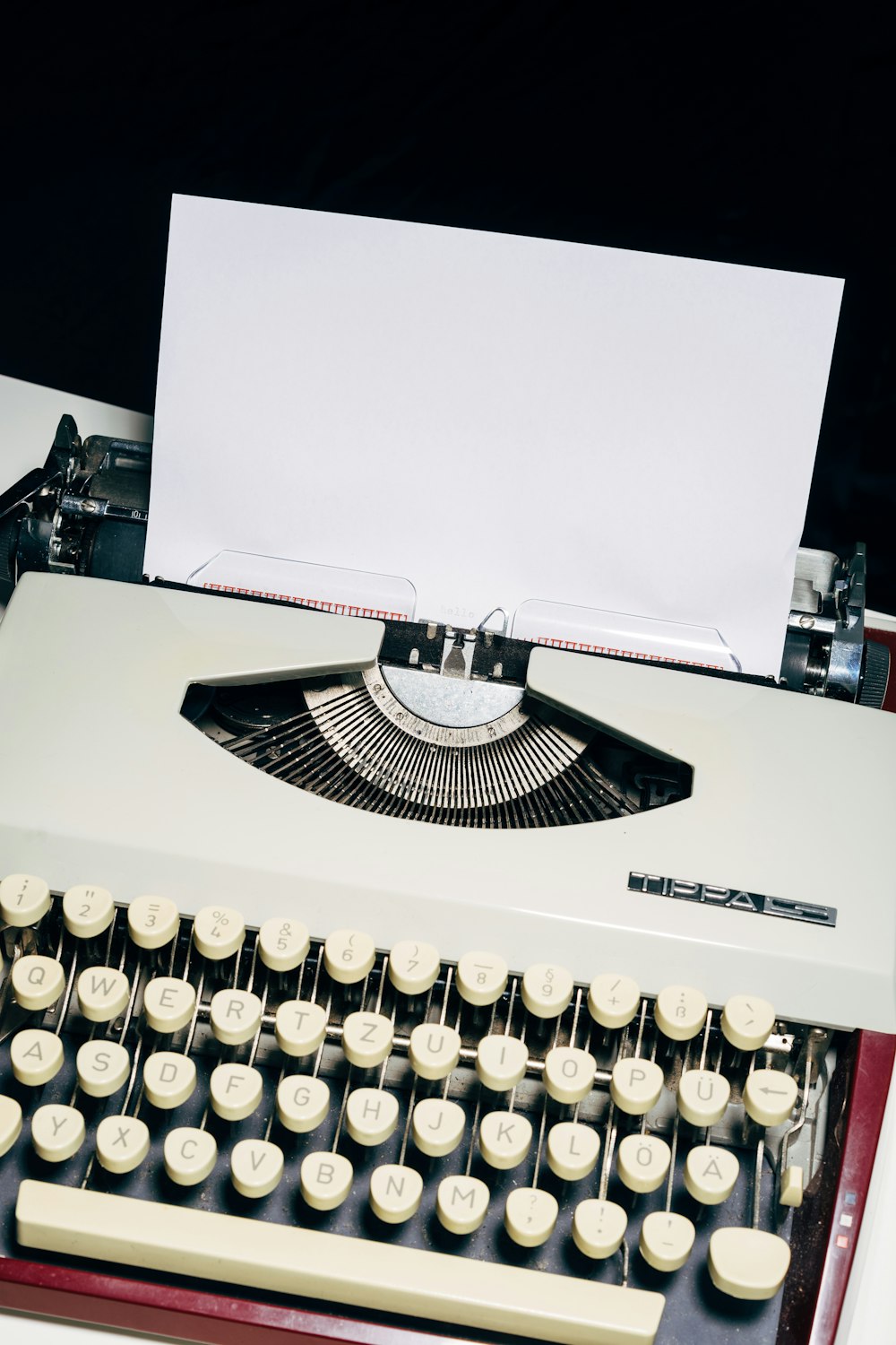 white and black typewriter on white table